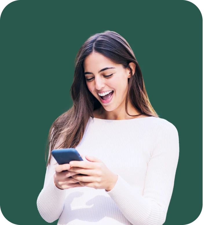 Laughing young woman reading her phone